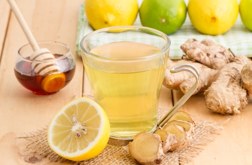 Cup of lemon tea surrounded by ingredients rich in vitamin C