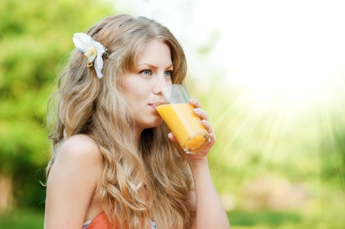 Beautiful woman having orange juice